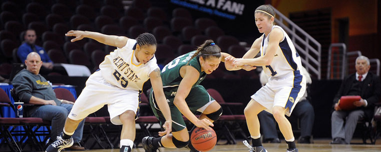 Kent State women's basketball players apply strong defensive pressure during a game at the Quicken Loans Arena, during the Mid-American Conference Tournament.