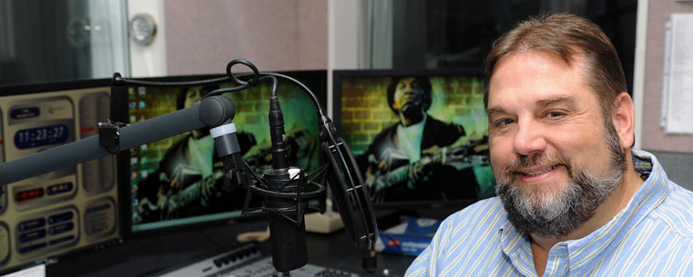 Matt Watroba, a WKSU Folk Alley host and producer, takes a break while producing a feature in one of the radio station’s studios.