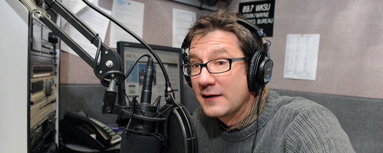 WKSU reporter and host Jeff St. Clair produces a show in a radio station studio.