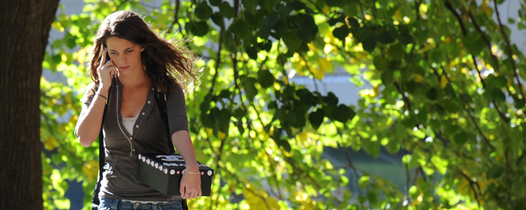 <p>A Kent State student makes a phone call during a walk between classes on campus.</p>