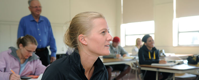 A Kent State student takes notes during class at a Regional Campus.