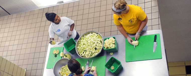 <p>Kent State student volunteers are reflected in a ceiling mirror in the food service kitchens of Beall Hall during community service work for the Campus Kitchen at Kent State during Welcome Weekend 2011. The Campus Kitchen at Kent State is an organization that prepares meals for local organizations in need.<br />
</p>