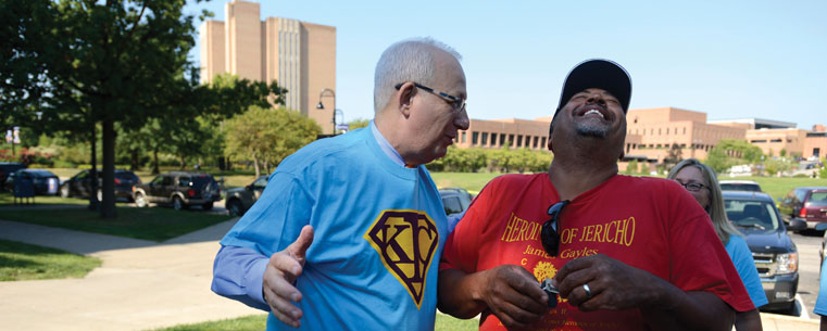 Dr. Lester Lefton jokes with the father of an incoming freshman during Movers and Groovers.