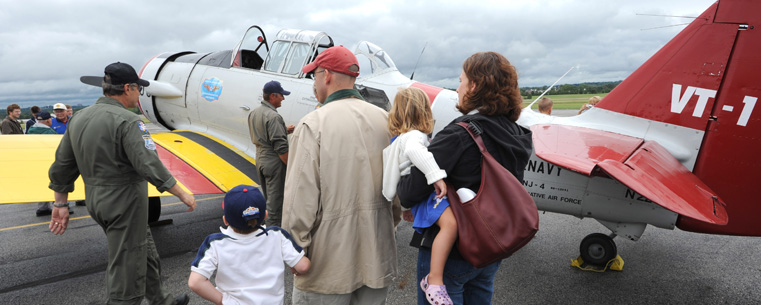 A family takes a close-up look at a Navy SNJ-4 trainer during a previous Aviation Heritage Fair.