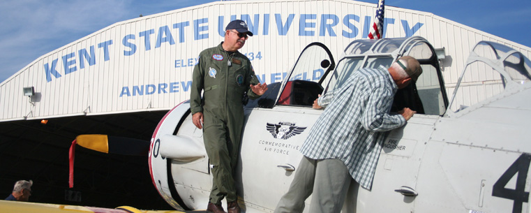 A visitor at a previous Aviation Heritage Fair checks out a vintage Navy SNJ-4 trainer at the Kent State University Airport. The plane belongs to the Cleveland Wing of the Commemorative Air Force.