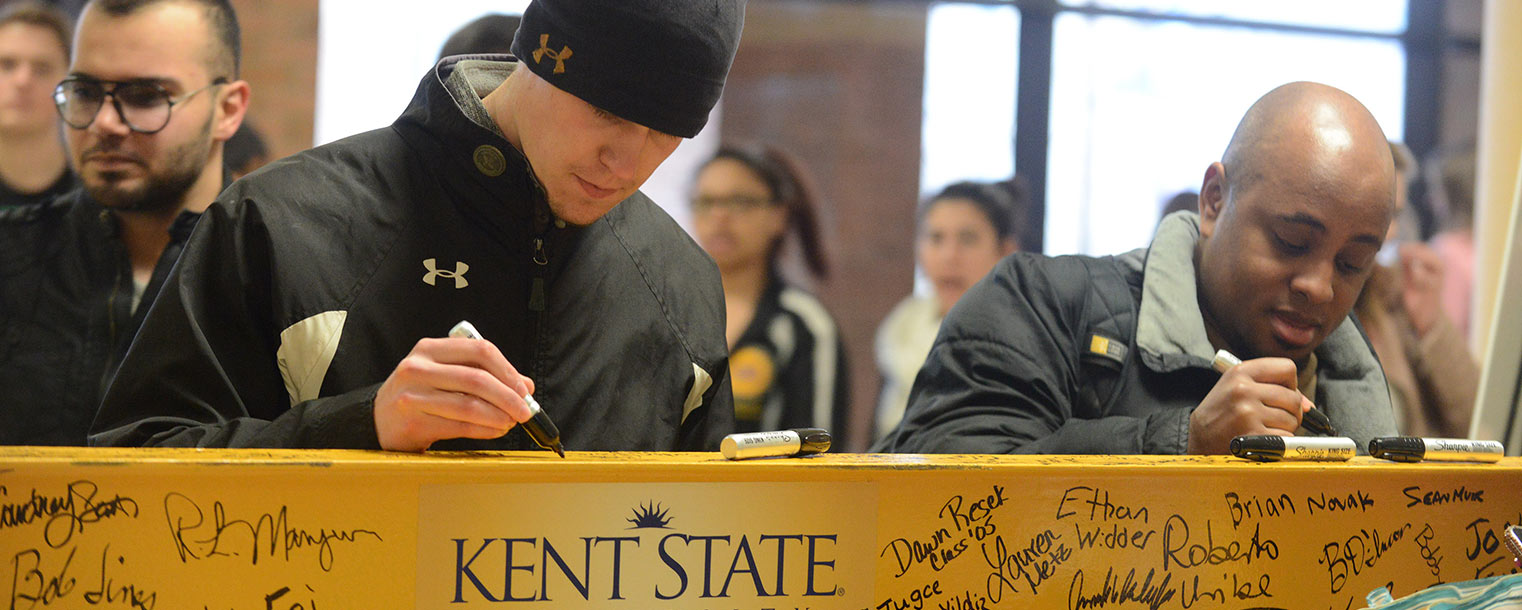 Kent State students and employees sign an I-beam that will be installed in the new building for the College of Applied Engineering, Sustainability and Technology. An event to welcome the addition of the college to the university’s Science Mall will take place April 23.