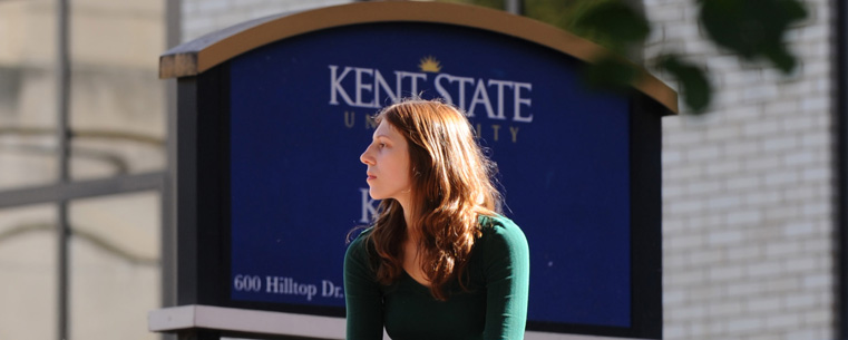 <p>A student studies near Kent Hall.</p>