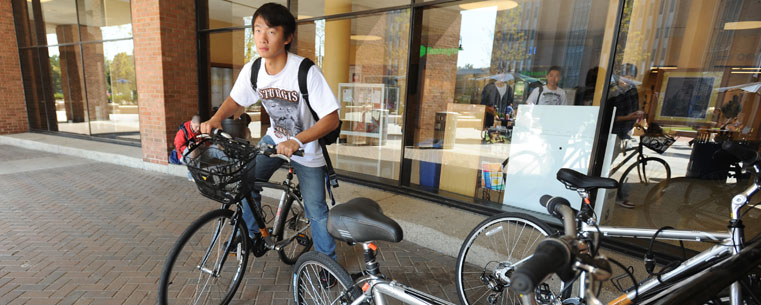 A student uses a bike he rented from the "Flash Fleet" on campus.