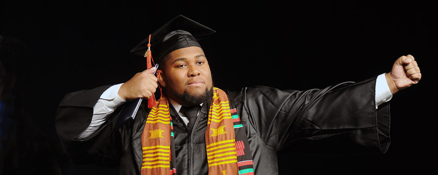 <p>A Kent State student celebrates after crossing the stage at Commencement.</p>