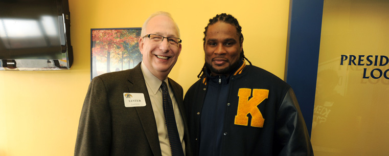 President Lester A. Lefton poses for a photo with Joshua Cribbs in the president's loge at Dix Stadium.