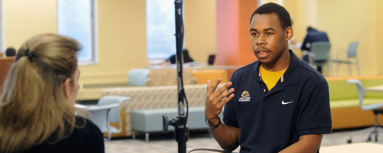 <p>Kent State student Willie Williams is interviewed by an ESPN producer in the “Fab Fourth,” the fourth floor of the Kent State University Library, for a feature story that aired Dec. 19 on ESPN’s Monday Night Football.</p>