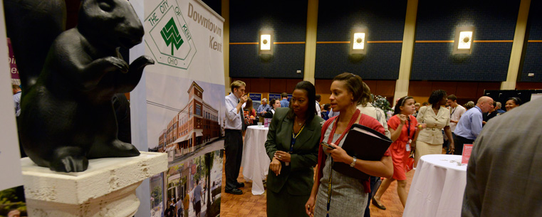 University community members look at the “Foundations of Excellence: Building the Future” exhibit.