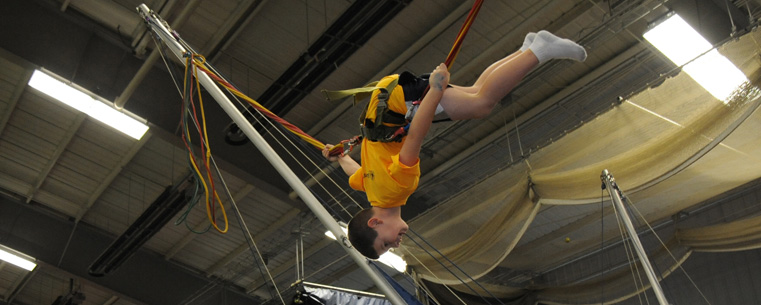 A child plays on the bungee machine during the Fan Experience held in the Kent State Field House before each football game.