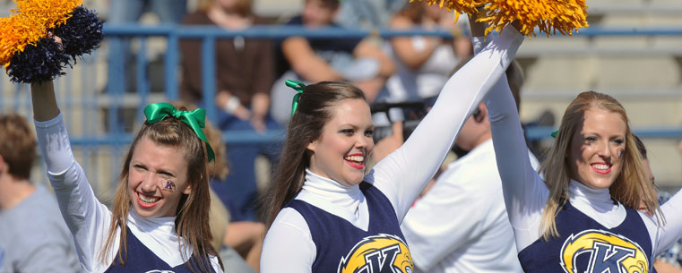 The Kent State cheerleaders cheer on the Golden Flashes during player introductions at Dix Stadium.<br />