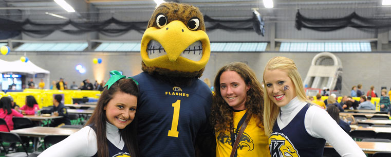 Flash, the Kent State University Golden Flashes mascot, joins members of the cheerleading squad to welcome students to the pre-game festivities in the Kent State Field House.