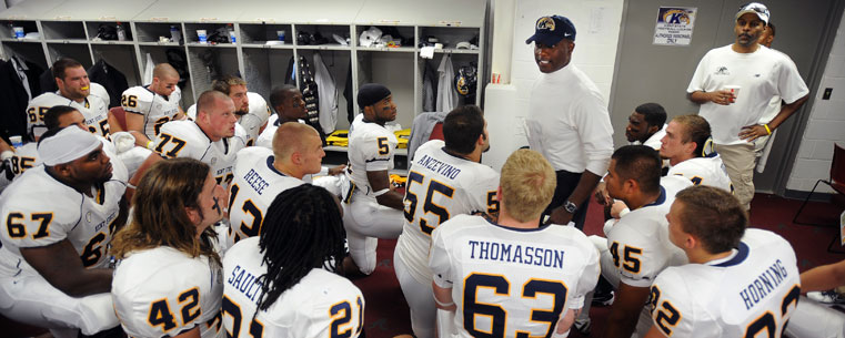 Head football coach Darrell Hazell goes over the game plan in the locker room prior to a game earlier this season.