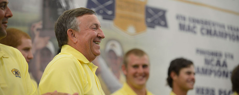 Golf Coach Herb Page, along with the golf team, is congratulated during a special ceremony at the Field House before Thursday's football game. Page led the Kent State Golf Team to a national 5th place.