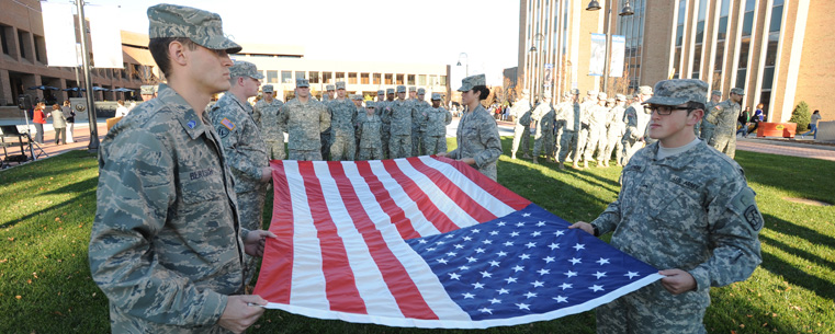 Two members of Kent State's ROTC Cadet Corps get ready to post the flag during the university's Veterans Day ceremony.