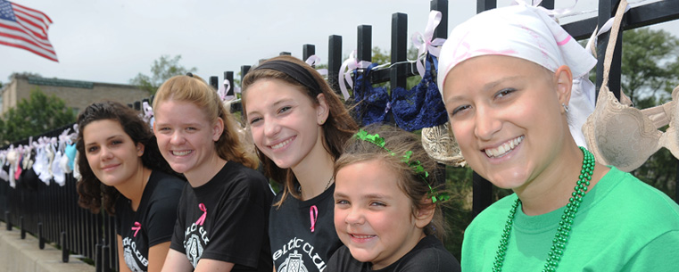 Marissa Manocchio, a Kent State student who is battling cancer, poses with local students who helped collect and display bras for the Bras Across the Crooked River event.