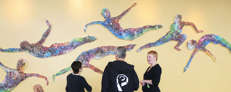 Eric Van Baars, associate professor of theatre, and Barbara Verlezza, associate professor of dance, speak with artist Olga Ziemska, right, after she began installation of her artwork in Kent State University's New Roe Green Center for the School of Theatre and Dance.