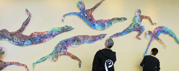 <p>Eric Van Baars, associate professor of theatre, and Barbara Verlezza, associate professor of dance, take a close look at the recently installed artwork created by Olga Ziemska in Kent State University's new Roe Green Center for the School of Theatre and Dance.</p>