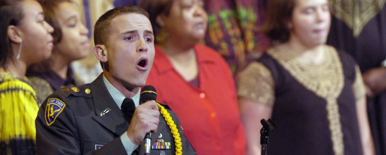 A member of the Kent State ROTC program sings along with the Kent State gospel choir during a previous event.