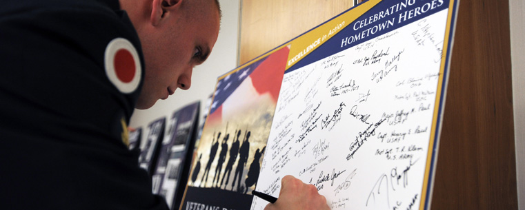 Guests attending last year's annual Kent State Veterans Day program sign a "thank you" card for former and current military personnel.