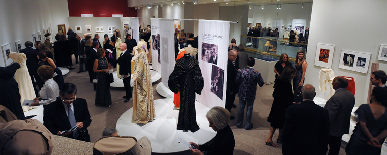 <p>Guests attending the "25 Years of Dazzle" celebration preview the Katharine Hepburn exhibition in the Kent State University Museum.</p>