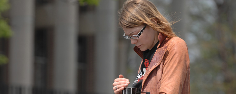 A Kent State University student stands vigil around noon on May 4 in the parking lot near Taylor Hall.