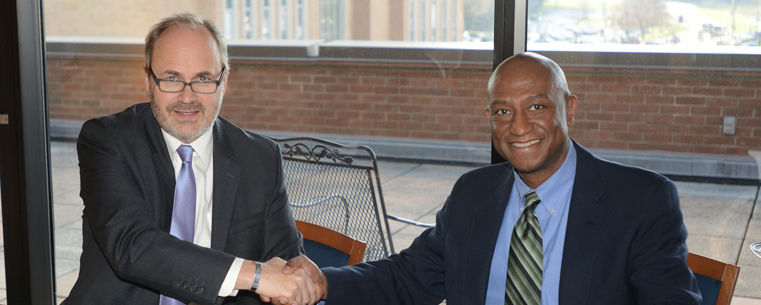 Todd Diacon, Kent State’s senior vice president for academic affairs and provost (left), and Stan Austin, superintendent of the Cuyahoga Valley National Park, signed the five-year agreement last month.