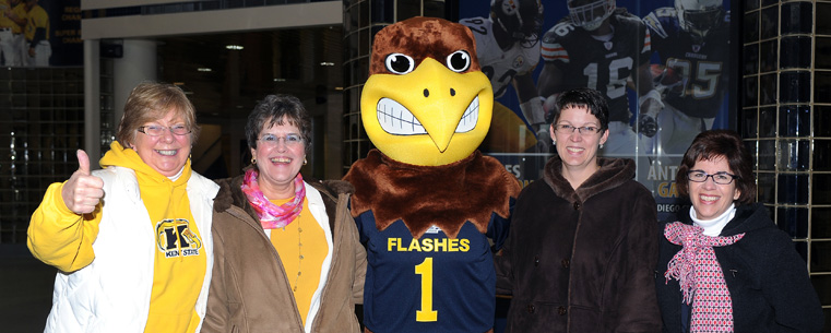 Kent State employees show their team spirit with Flash, the university’s mascot, as they enter the MAC Center for a send-off event as the football team heads to the Mid-American Conference championship game in Detroit.