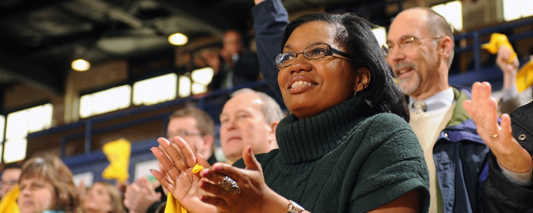 Kent State faculty, staff and students, as well as community members, cheer as the football team enters the MAC Center for a send-off event as the Golden Flashes head to Detroit for the Mid-American Conference championship game.