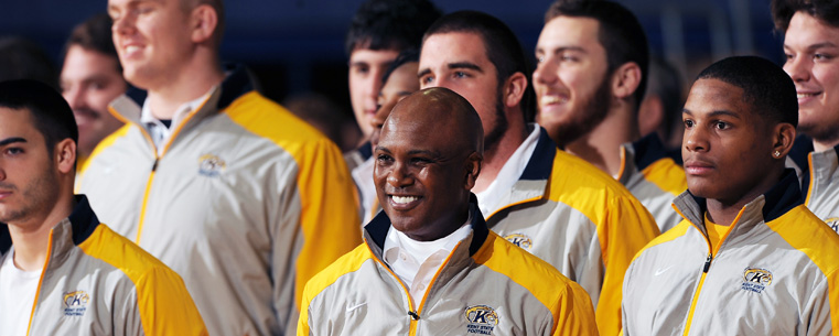 Members of the Kent State football team and Kent State head football coach Darrell Hazell (center) receive applause and cheers from the crowd in attendance at the Mid-American Conference championship send-off event held in the MAC Center.