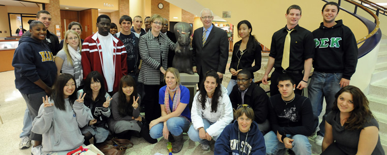 Students, Linda Lefton and President Lefton unveil a bronze squirrel to launch the centennial kick off.