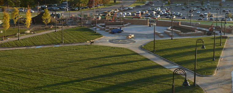 Pictured is the Student Green, as seen one week prior to its dedication from the roof of the Kent Student Center. Located at the heart of the campus, the new Student Green is a place for students to relax, study and enjoy. It also provides outdoor programming space to student organizations on campus and offers a performance stage that is intended to support student use.