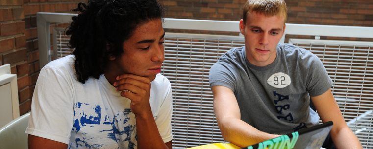 Two Kent State students study before class in the Business Administration Building.