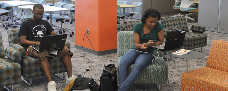 Kent State students use their laptops and phones as they study in the “Fab Fourth” on the fourth floor of the University Library.