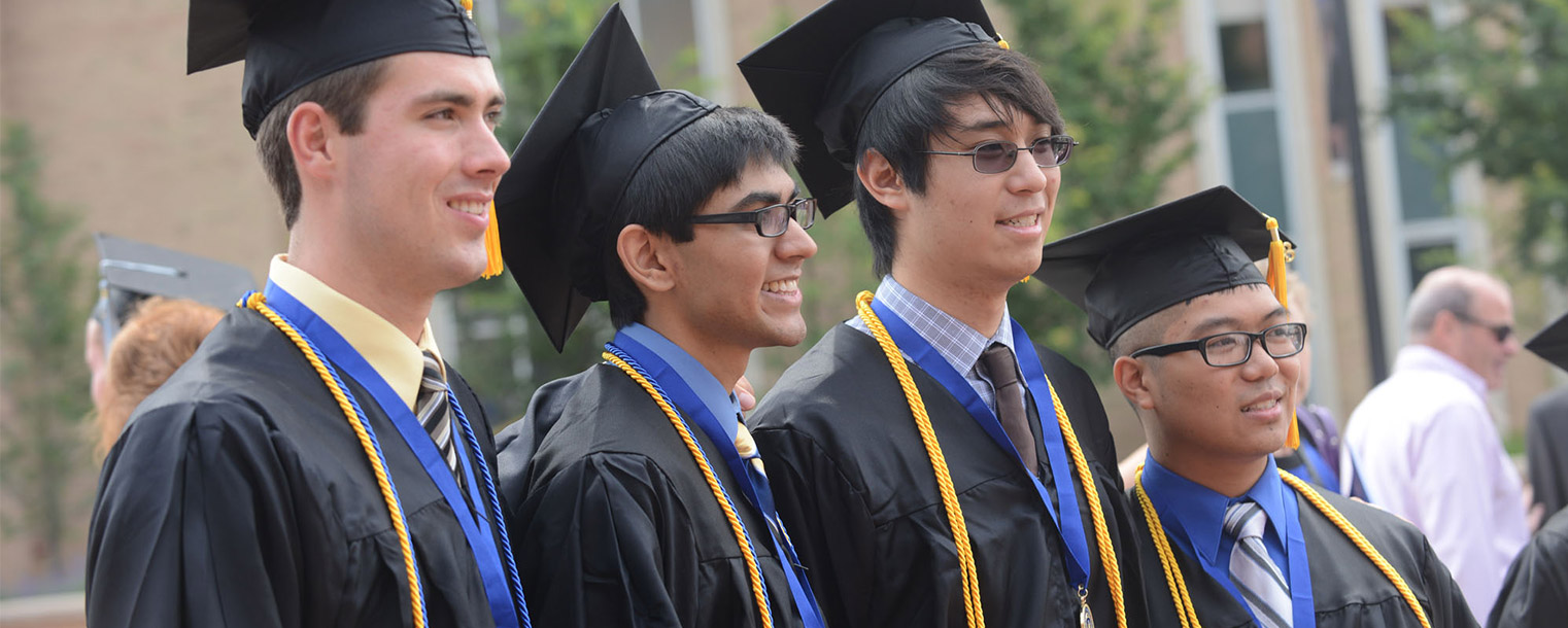 <p>A group of friends poses for photos on Risman Plaza after Kent State's summer 2013 commencement.</p>