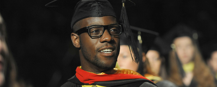 An August 2011 graduate scans the crowd during commencement ceremonies.