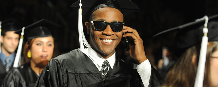 A summer 2011 graduate talks to his family during the processional.