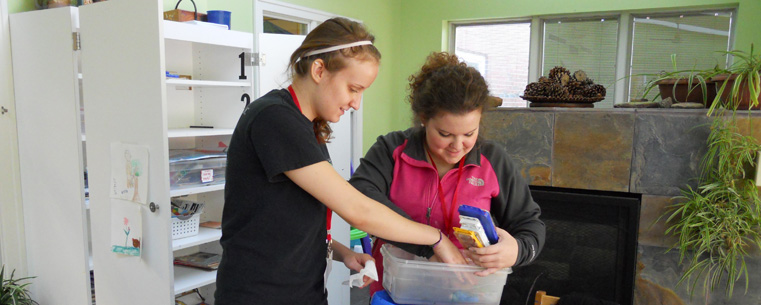 Kent Student Ambassadors Stephanie Petcavage (left) and Jessica Graning (right) organize art supplies in a craft room at the Ronald McDonald House in Cleveland. The ambassadors cleaned and made breakfast at the house as part of a Super Service Saturday experience.<br />