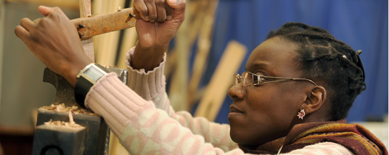 <p>Katia Melchiades, a teacher from Brazil, uses carving tools to make a wooden spoon during a class at the Spring Garden Waldorf School near Akron.</p>