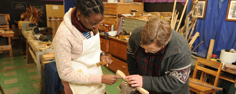 <p>Adam Kuhn, right, works with Katia Melchiades, a teacher from Brazil, on her woodworking project at the Spring Garden Waldorf School near Akron.</p>