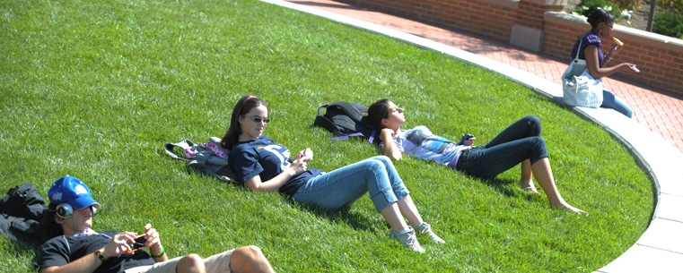 <p>Students relax in the grass area in the Risman Plaza in front of the Kent Student Center.<br />
</p>