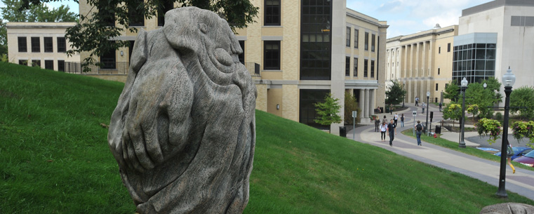 <p>Students pass by the sculpture “Athleta” by Ohio artist Giancarlo Calicchia near Kent Hall along the Kent State University Esplanade.</p>