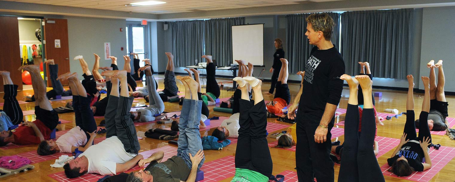 A yoga instructor walks his class through a series of exercises in Kent State’s Student Recreation and Wellness Center.