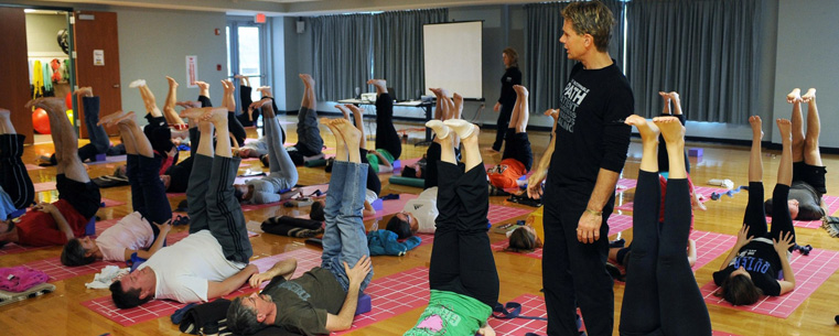 A yoga instructor walks his class through a series of exercises in Kent State’s Student Recreation and Wellness Center.