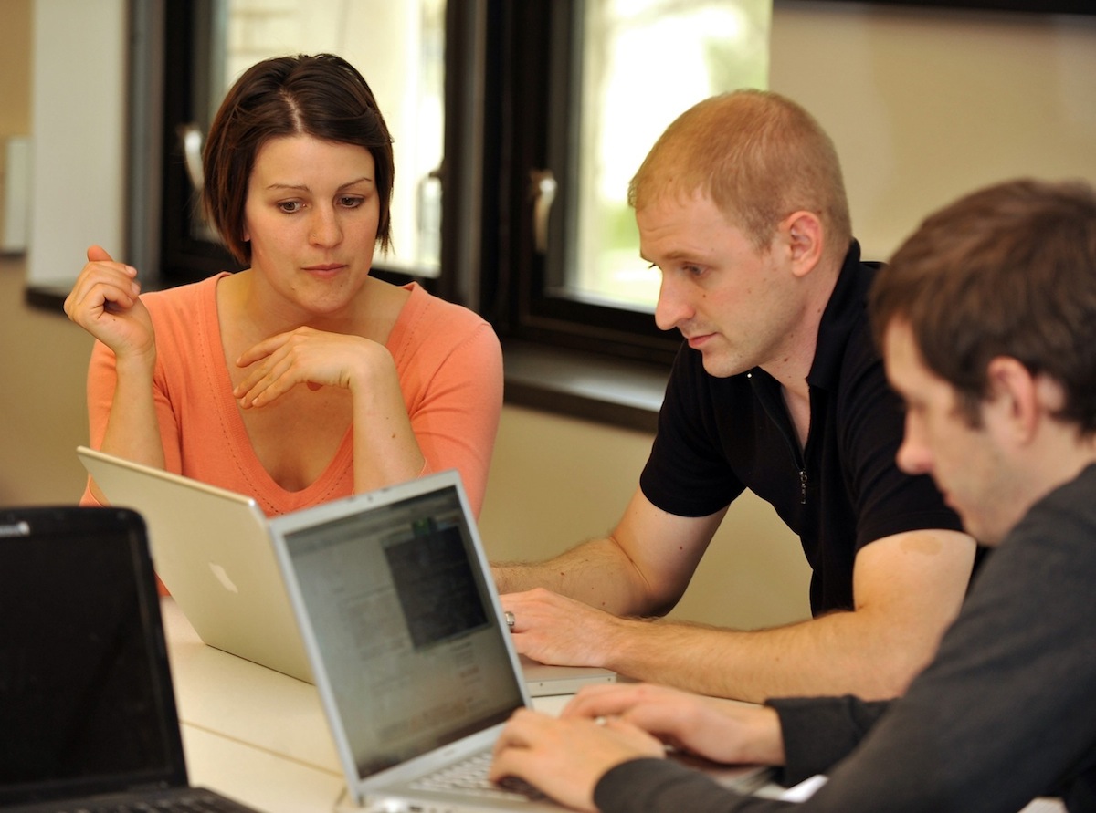 Kent State students and an instructor work on the OpenCampus Kent website