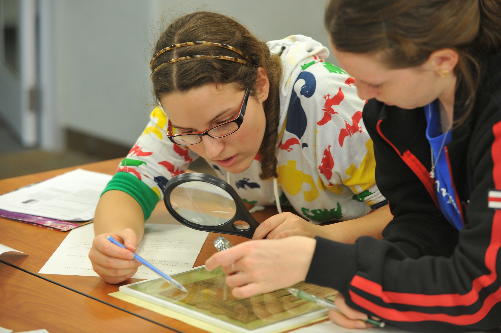 Kent State University undergraduate students Ola Sobieska and Heather Benya study an ancient Greek papyrus document as part of the international Green Scholars Initiative.