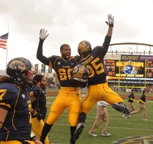 Golden Flashes players Charles Chandler and Julian Durden celebrate Kent's victory over Ohio during the final home game. The Flashes won all of their MAC games this year and are headed to the league championship game.